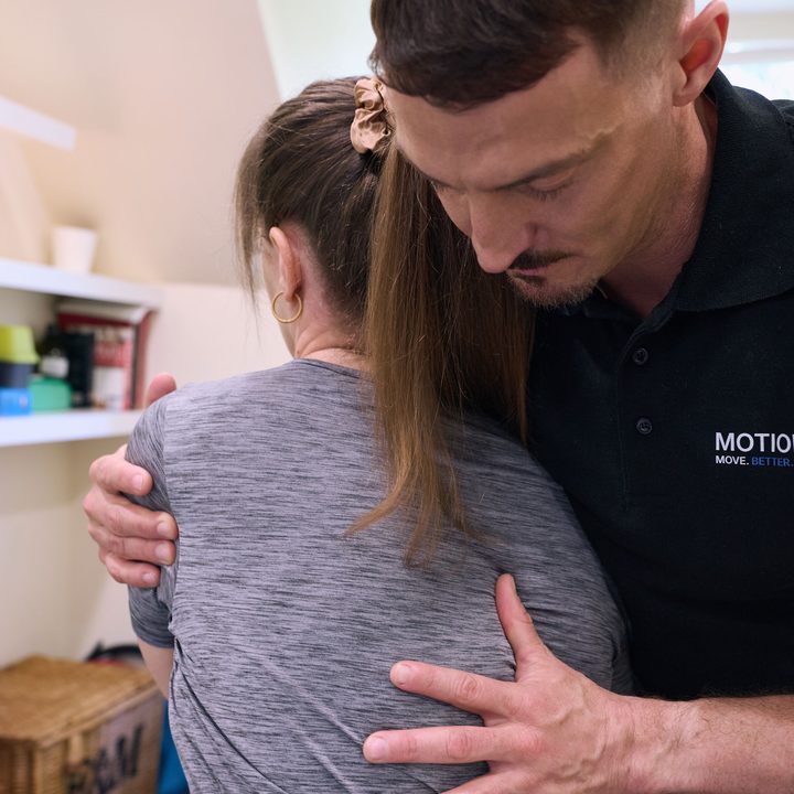 Chiropractor treating a patient's back at MotionFix